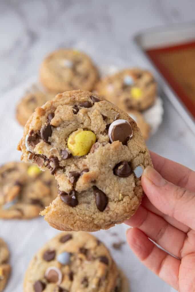 main tenant un cookie Cadbury avec une bouchée