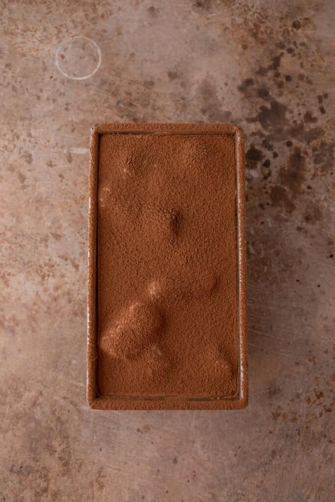 Deuxième couche dans le moule, saupoudrée de cacao